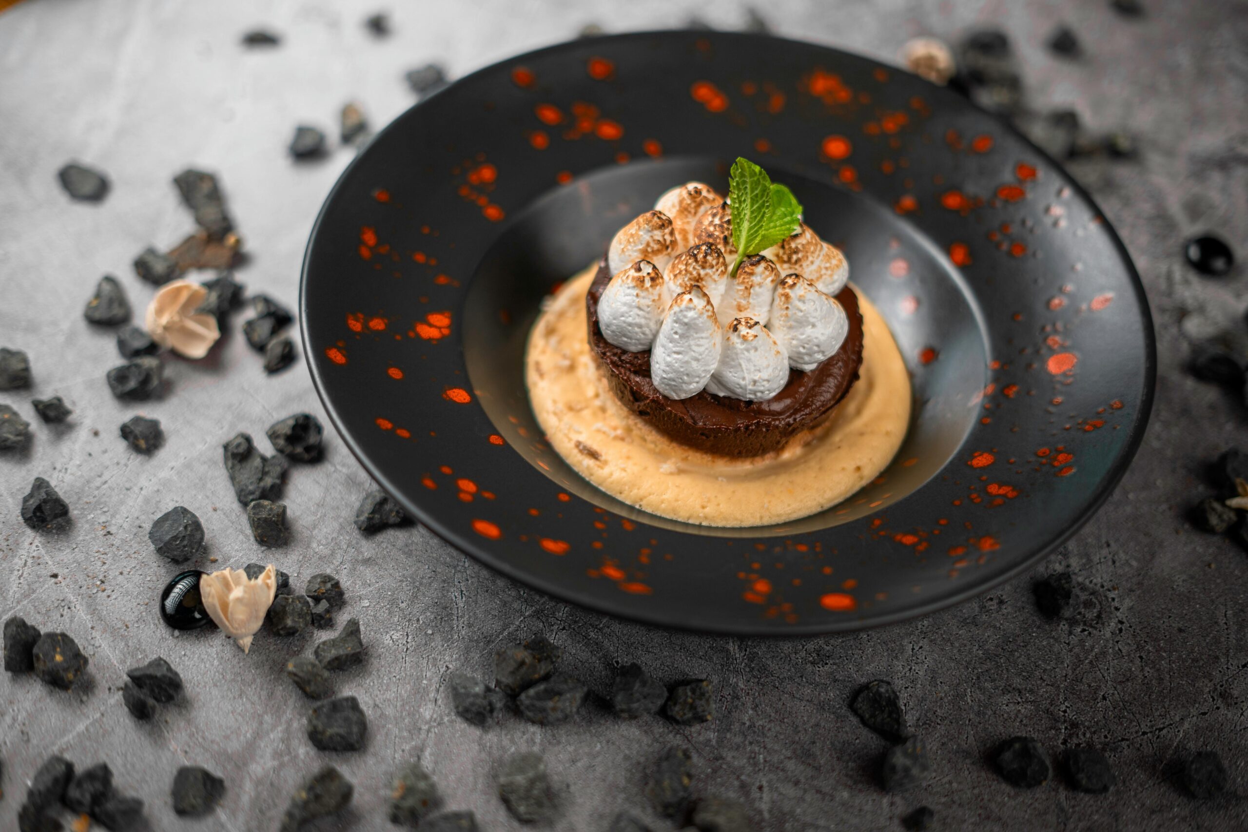 Elegant chocolate dessert with whipped topping and mint, perfect for gourmet dining.